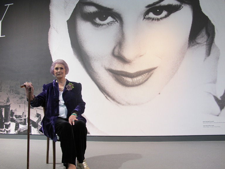 April Ashley sat in front of a large photograph of herself