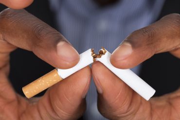 A cigarette being snapped in half