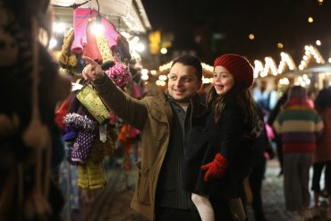 A father and daughter enjoying the Christmas market