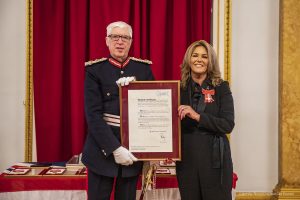 Mark Blundell, Lord-Lieutenant of Merseyside presents Julie Cashin with her MBE.