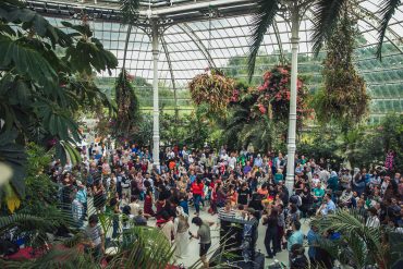 Large gathering of people in Sefton Park Palm House