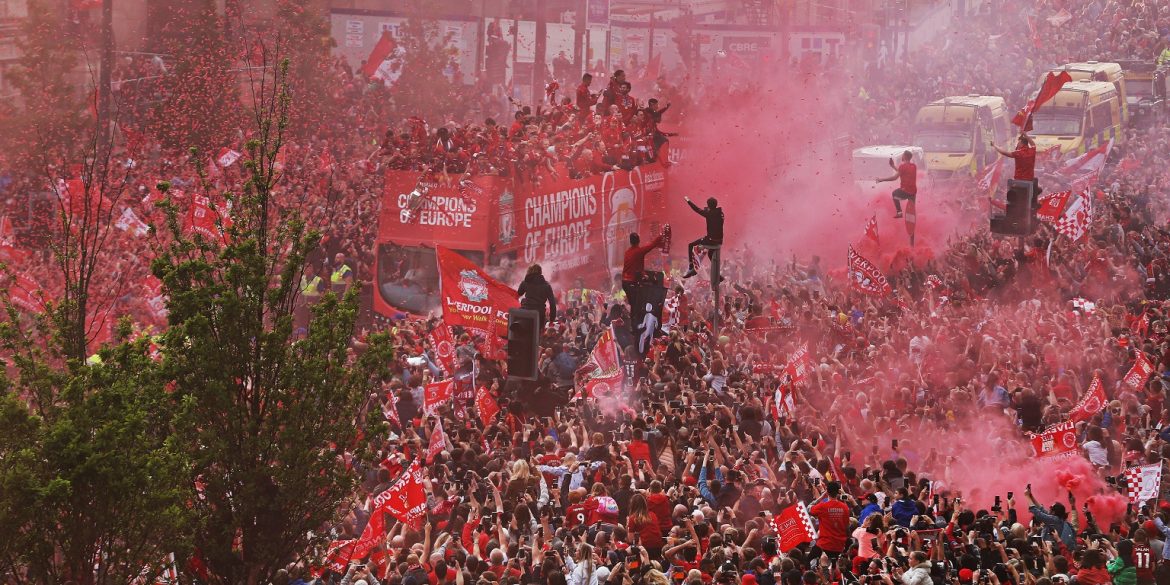 LFC fans line homecoming parade route on The Strand with the LFC 'Champions of Europe' bus in the centre. It's a sea of red.