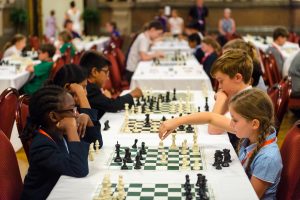 A groups of young girls playing chess at St George's Hall, Liverpool