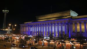 Night image of St George's Hall with Christmas market stalls on the plateau