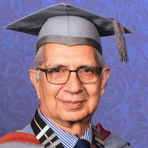 A man wearing n academic gown and mortar board