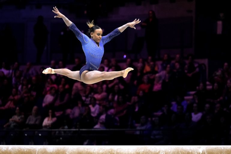 Woman gymnast performing on the beam