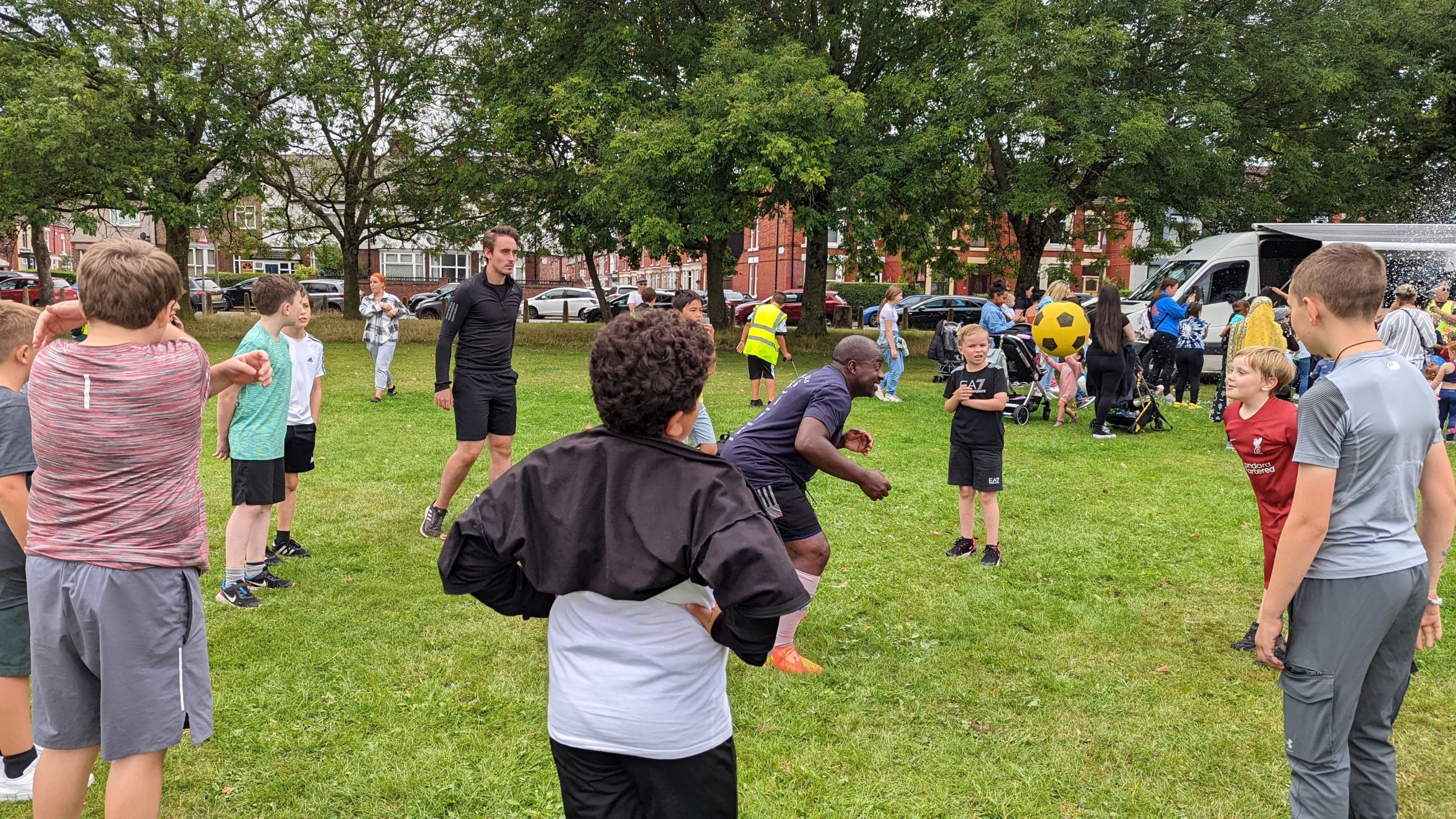 Children playing football in a park