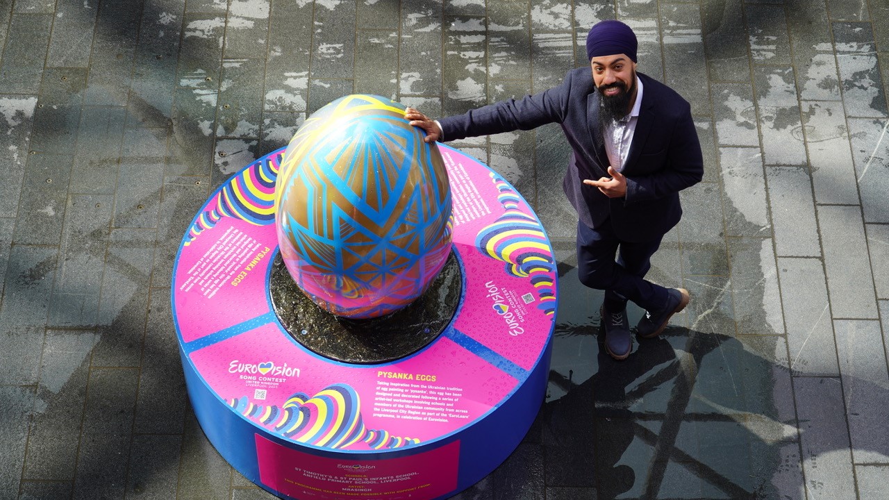 Artist with colourful egg sculpture