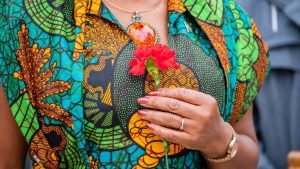 Close up of a woman holding a red carnation