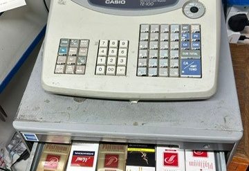 Packets of illicit cigarettes hidden in the drawer of a shop till.