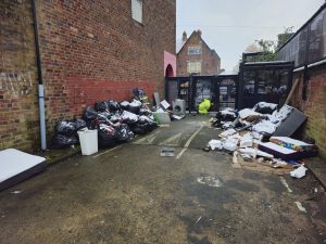 Fly tipping in a residential alleyway