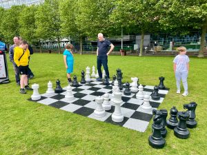 A group of people playing on a giant chess set at Liverpool ONE
