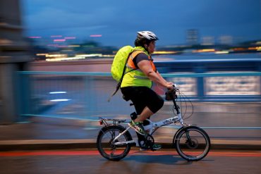 A person cycling in the dark.