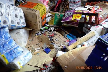 Boxes and household goods piles up with mouse droppings among them.