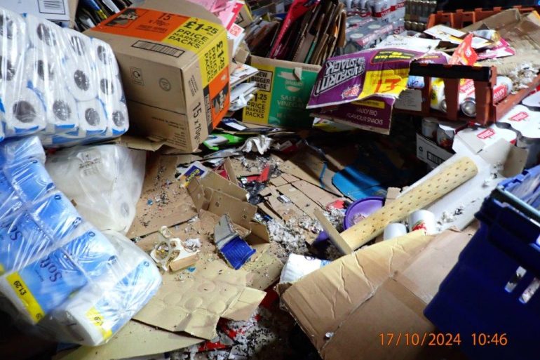Boxes and household goods piles up with mouse droppings among them.