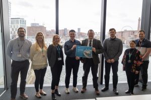 Group photo in front of Liverpool docks.