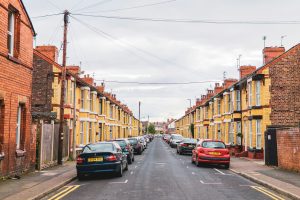 Liverpool street of houses with cars parked on the road.