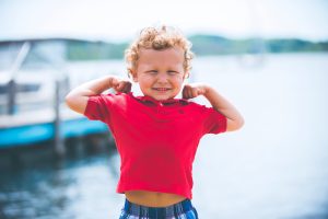 Young boy in front of the sea.