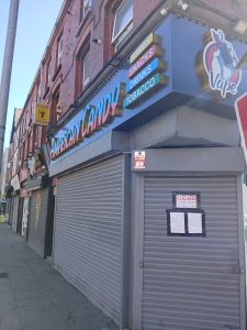 A shop front with a closure order on the shutters.