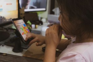 Young girl playing a game on their phone