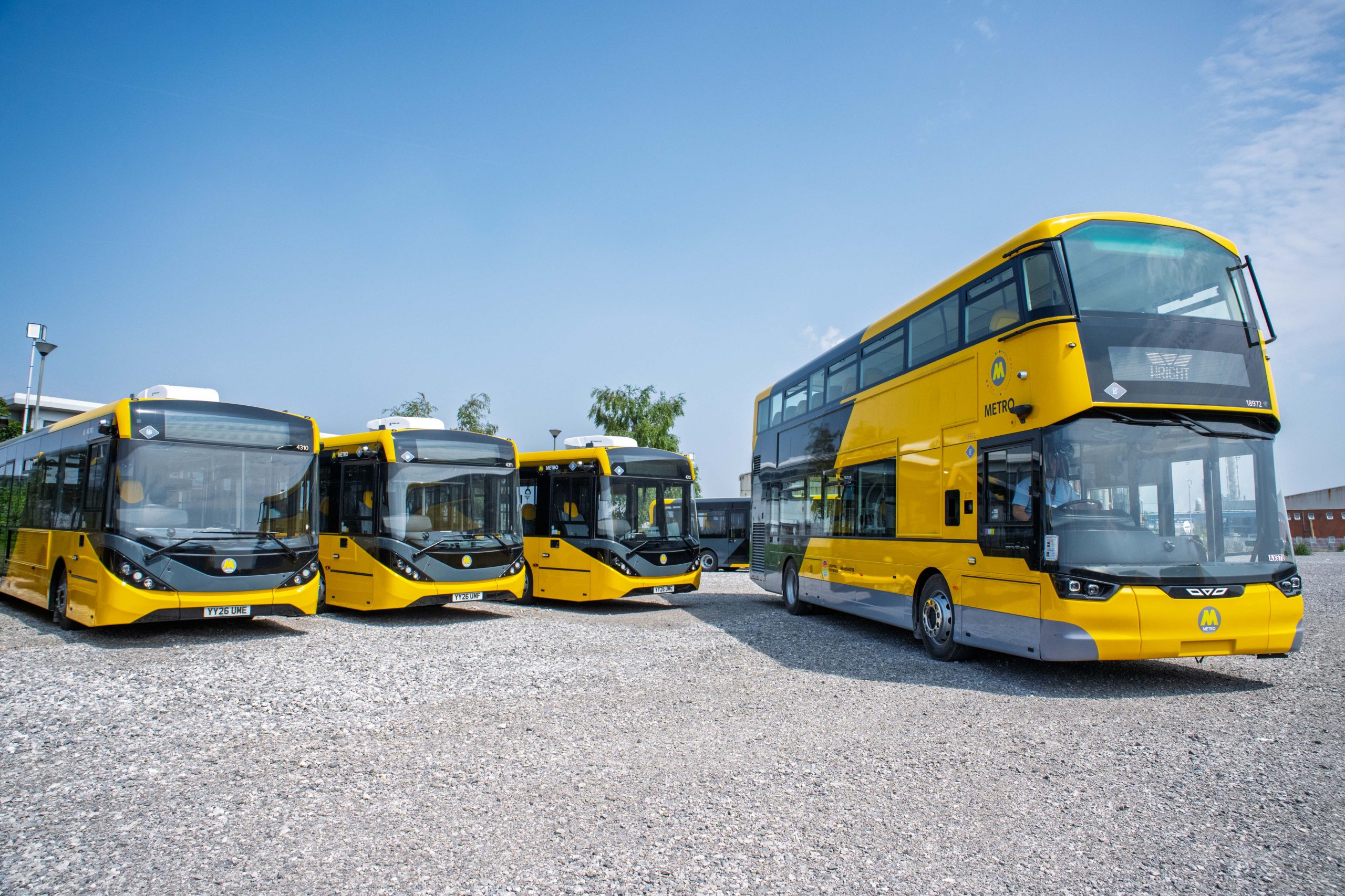 A group of buses painted yellow and black